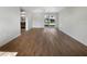 Bright living room with wood-look floors and sliding glass doors leading to the backyard at 290 Dragon Rd, Venice, FL 34293