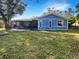 House exterior showcasing a screened patio and spacious grassy backyard at 4143 Waikiki Dr, Sarasota, FL 34241