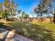 Large backyard with fire pit and wooden fence at 4143 Waikiki Dr, Sarasota, FL 34241