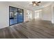 Spacious living room with wood-look floors, and access to patio at 4143 Waikiki Dr, Sarasota, FL 34241