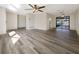 Spacious living area featuring wood-look floors and sliding glass doors at 4143 Waikiki Dr, Sarasota, FL 34241