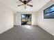 Bright bedroom featuring grey carpet and sliding glass doors at 4143 Waikiki Dr, Sarasota, FL 34241