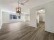 Open living room showcasing wood-look floors and a modern light fixture at 4143 Waikiki Dr, Sarasota, FL 34241
