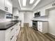 Modern kitchen with white shaker cabinets, quartz countertops, and stainless steel appliances at 4143 Waikiki Dr, Sarasota, FL 34241