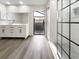 Modern bathroom with double vanity, large shower, and wood-look flooring at 4143 Waikiki Dr, Sarasota, FL 34241