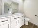 Updated bathroom features a double vanity, a large mirror, and a modern toilet at 4143 Waikiki Dr, Sarasota, FL 34241