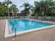 Inviting community pool surrounded by lush tropical landscaping at 642 Bird Bay E Dr # 205, Venice, FL 34285