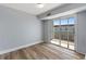 Bedroom with wood-look floors and sliding glass door to balcony at 3315 58Th S Ave # 508, St Petersburg, FL 33712