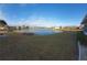 Expansive backyard view showcases a serene lake, enhancing the property's appeal and outdoor living potential at 906 Bluewater Dr, Sun City Center, FL 33573