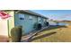 Backyard of house with grass and a lake in the background at 906 Bluewater Dr, Sun City Center, FL 33573
