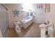 Bright bathroom with vanity, tiled floors, and colorful toilet seat at 906 Bluewater Dr, Sun City Center, FL 33573