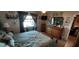 Cozy bedroom featuring a bed, dresser, and a window with curtains at 906 Bluewater Dr, Sun City Center, FL 33573