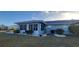 This home features a screen room and decorative rock landscaping around the house at 906 Bluewater Dr, Sun City Center, FL 33573