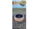 Fire pit surrounded by grass with a view of the lake at 906 Bluewater Dr, Sun City Center, FL 33573
