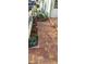 Brick path leading to the front door with a well-manicured garden and lawn at 906 Bluewater Dr, Sun City Center, FL 33573