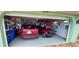 Well-organized garage featuring a car, golf cart, and custom flooring at 906 Bluewater Dr, Sun City Center, FL 33573