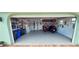 Spacious and organized garage featuring motorbikes, ample storage and work area, and custom flooring at 906 Bluewater Dr, Sun City Center, FL 33573