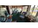 Bright sun room features wicker seating and large windows overlooking the waterfront at 906 Bluewater Dr, Sun City Center, FL 33573