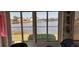 Windows showcase beautiful waterfront views with fountain and neighborhood homes at 906 Bluewater Dr, Sun City Center, FL 33573