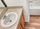 Bathroom with a vanity sink, wood cabinets and a view of the tub at 922 Wynnmere Walk Ave, Ruskin, FL 33570