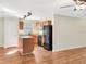 Modern kitchen with island, wood cabinets, and black appliances at 922 Wynnmere Walk Ave, Ruskin, FL 33570