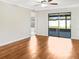 Spacious living area featuring hardwood floors and sliding glass doors at 922 Wynnmere Walk Ave, Ruskin, FL 33570