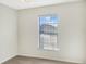 Well-lit bedroom featuring a window with blinds and neutral walls at 922 Wynnmere Walk Ave, Ruskin, FL 33570