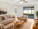 Bright living room with hardwood floors, comfy furniture, and access to a patio at 922 Wynnmere Walk Ave, Ruskin, FL 33570