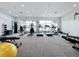 Modern fitness center with various exercise equipment and lake views at 10530 Boardwalk Loop # 304, Lakewood Ranch, FL 34202