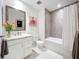 Clean bathroom with a bathtub, shower, and white cabinets at 10530 Boardwalk Loop # 304, Lakewood Ranch, FL 34202