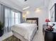 Bright bedroom with a queen-size bed and plenty of natural light at 10530 Boardwalk Loop # 304, Lakewood Ranch, FL 34202