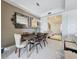 Modern dining room with a wood table and ornate mirrors at 10530 Boardwalk Loop # 304, Lakewood Ranch, FL 34202