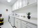 Laundry room with washer, dryer, cabinets, and a sink at 10530 Boardwalk Loop # 304, Lakewood Ranch, FL 34202