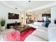 Open living room showcasing a sectional sofa, coffee table, and large TV at 10530 Boardwalk Loop # 304, Lakewood Ranch, FL 34202