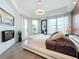 Main bedroom with a king bed, fireplace, and expansive windows at 10530 Boardwalk Loop # 304, Lakewood Ranch, FL 34202