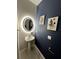 Stylish powder room with a pedestal sink, dark blue walls, and framed art at 10922 Brightleaf Ct, Riverview, FL 33569
