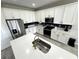 Modern kitchen with white cabinets, stainless steel appliances, and a large island at 10922 Brightleaf Ct, Riverview, FL 33569