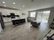 Open kitchen with white cabinets, island, and stainless steel appliances at 10922 Brightleaf Ct, Riverview, FL 33569