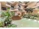 Interior of atrium featuring a water feature, seating, and lush greenery at 2413 Bayshore Blvd # 1404, Tampa, FL 33629