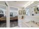 Bright bathroom with a dual vanity, framed mirrors and a view to the bedroom suite at 2413 Bayshore Blvd # 1404, Tampa, FL 33629