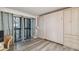 Bright bedroom with hardwood floors, large sliding glass doors to a balcony, and a built-in Murphy bed and storage at 2413 Bayshore Blvd # 1404, Tampa, FL 33629