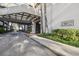 Building's covered entrance showcasing glass canopy and mature landscaping at 2413 Bayshore Blvd # 1404, Tampa, FL 33629