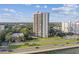Exterior view of a high-rise condominium featuring a swimming pool, and lush landscaping at 2413 Bayshore Blvd # 1404, Tampa, FL 33629