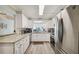 Bright kitchen featuring white cabinetry, granite countertops, stainless steel appliances, and a view of the city at 2413 Bayshore Blvd # 1404, Tampa, FL 33629