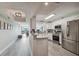 Open-concept kitchen with white cabinets, stainless steel appliances, and views of the living area and city skyline at 2413 Bayshore Blvd # 1404, Tampa, FL 33629