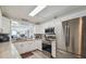 Charming kitchen with white cabinets, stainless steel appliances, granite counters, and a view through to the living area at 2413 Bayshore Blvd # 1404, Tampa, FL 33629