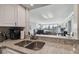 View of kitchen sink overlooking the living area with city views, featuring granite countertops and white cabinetry at 2413 Bayshore Blvd # 1404, Tampa, FL 33629