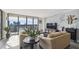 Bright living room features a stone accent wall and expansive windows with city views at 2413 Bayshore Blvd # 1404, Tampa, FL 33629