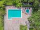 Aerial view of a community pool and hot tub surrounded by brick patio and lush landscaping at 2413 Bayshore Blvd # 1404, Tampa, FL 33629