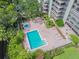 Aerial view of a community pool area and hot tub next to a high rise building at 2413 Bayshore Blvd # 1404, Tampa, FL 33629